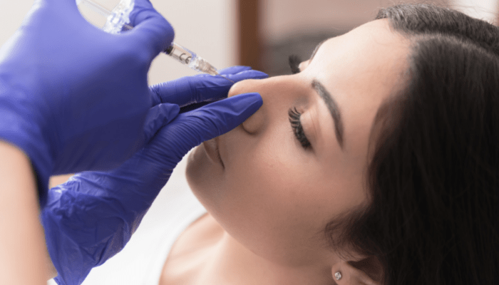 Doctor giving anesthesia during Rhinoplasty